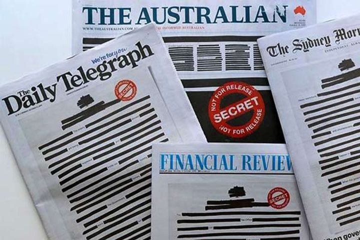 Australia Newspaper Blackout out text beside red stamps 