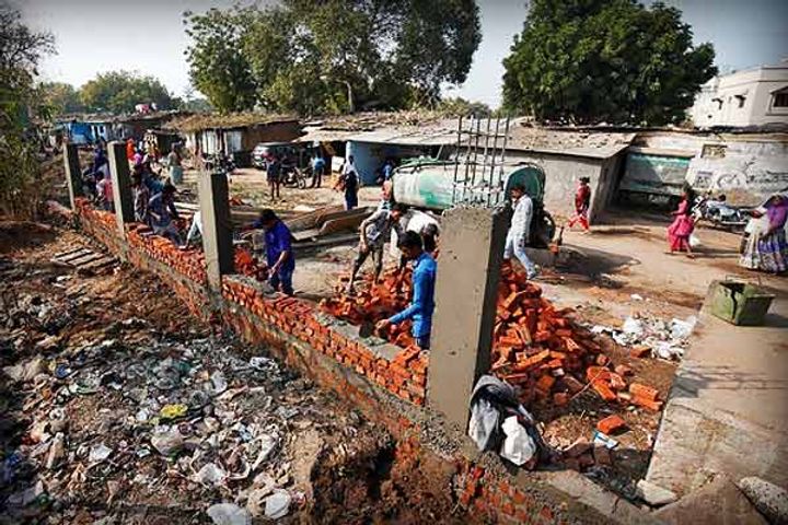 High walls built in front of slums to hide Gujarat  poverty from trump