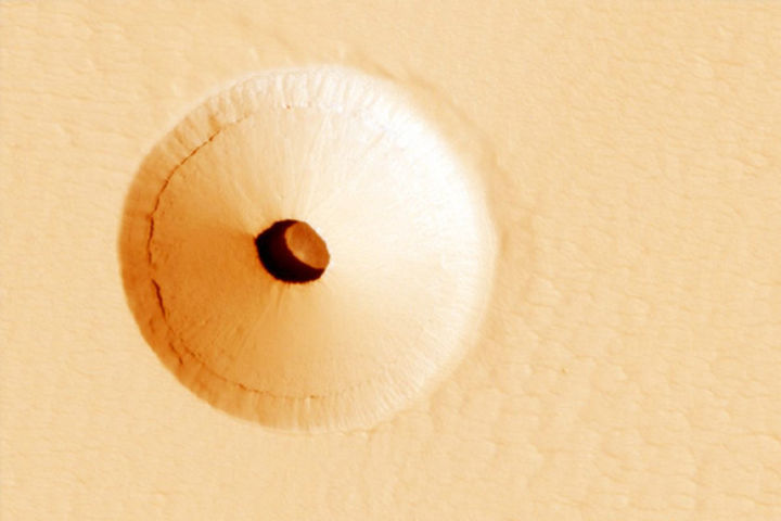 NASA Reveals Bizarre Picture of Mysterious Hole on Slopes of Massive Martian Volcano