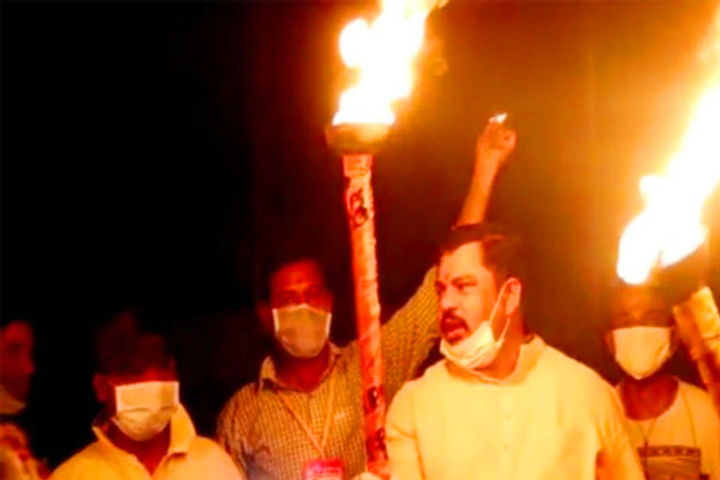 BJP MLA lights torch chants slogan against Covid-19 with supporters in Hyderabad
