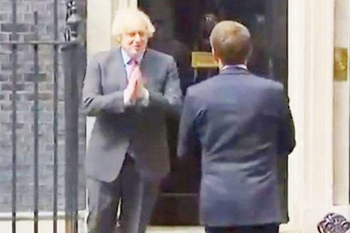 UK PM Boris Johnson and France President Emmanuel Macron namaste as they meet in London
