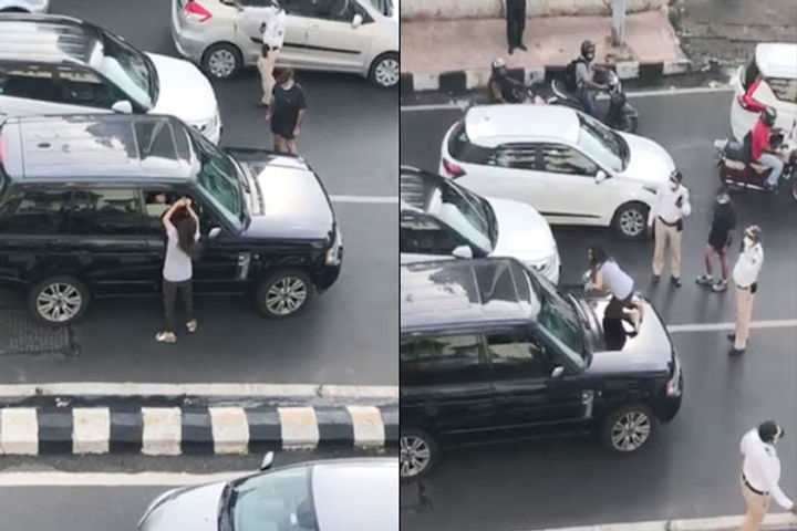 Woman chases husband car stands in front of his car to block traffic