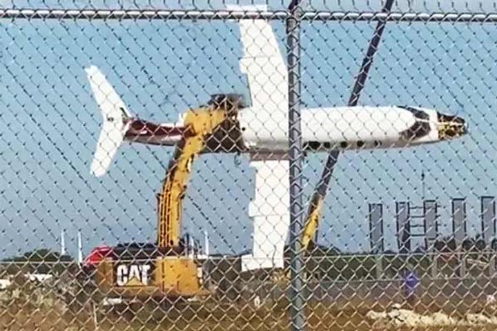 Man uses excavator to fly&amprsquo aircraft
