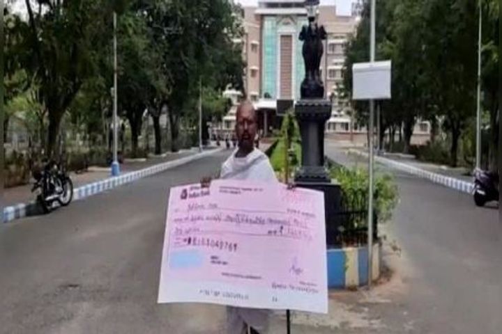 A man in Gandhi dress arrived to help the debt ridden Tamil Nadu government