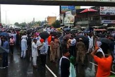 Angry farmers stand on National Highway 44 due to non government procurement of paddy